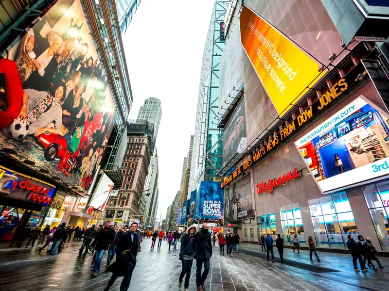 Crowds of tourists exploring Times square  during winter holiday